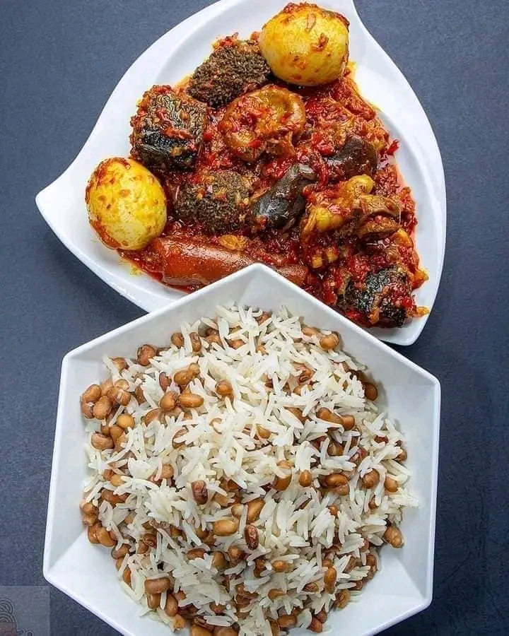 white rice and beans and a plate of tomato sauce filled with eggs,beef and pomo
